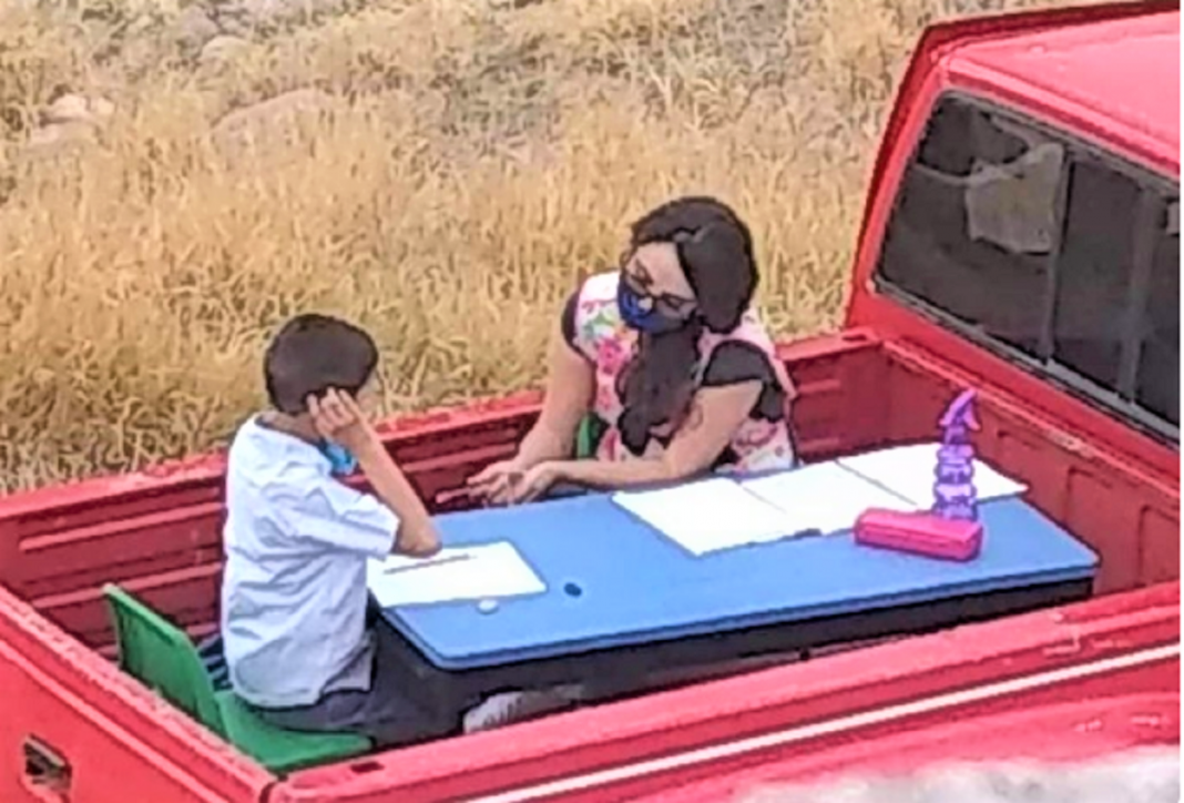 Professora transforma seu carro em mini sala de aula móvel e orienta seus alunos individualmente